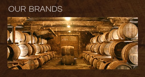 Our Brands — wine cellar with barrels